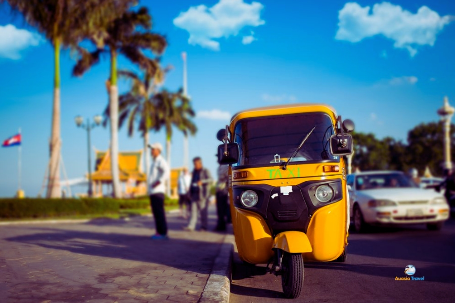 Yellow tuk tuk taxi in Phnom Penh Cambodia street – Auasia Travel